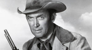 Caption: Legendary Actor James Stewart Exuding An Effortless Cowboy Style. Wallpaper