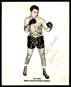 Caption: Legendary Boxing Champion Joey Maxim Signing An Autograph Wallpaper