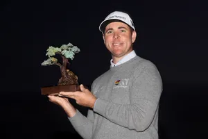 Caption: Luke List Admiring A Bonsai Tree Wallpaper