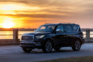 Caption: Luxurious Infiniti Qx80 In A Scenic Landscape Wallpaper