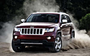 Caption: Luxurious Jeep Grand Cherokee Cruising In The Wild Wallpaper