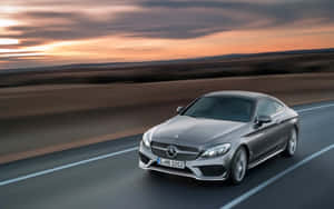 Caption: Luxurious Mercedes Benz C-class Amidst The Sunshine Wallpaper