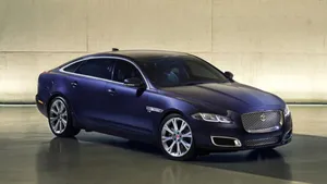 Caption: Luxurious Movement - Jaguar Xj In Flight Wallpaper