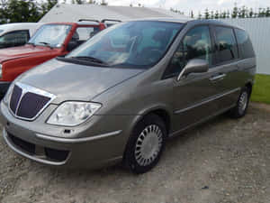 Caption: Luxury Lancia Phedra Minivan On The Road Wallpaper