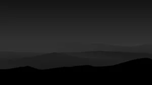 Caption: Majestic Dark Mountain At Sunset Wallpaper