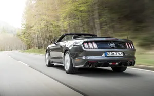 Caption: Majestic Ford Mustang Gt Convertible On The Street Wallpaper