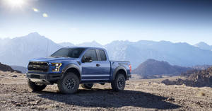 Caption: Majestic Ford Raptor Exploring Wild Mountain Terrains Wallpaper