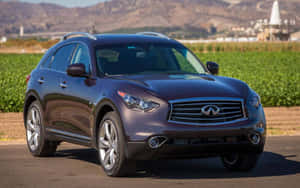 Caption: Majestic Infiniti Qx70 Gliding Down The Highway Wallpaper