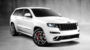 Caption: Majestic Jeep Grand Cherokee In Wilderness Wallpaper