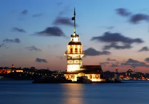 Caption: Majestic Maiden Tower Illuminated At Sunset Wallpaper