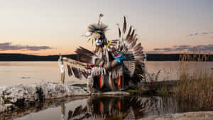 Caption: Majestic Native Warrior By The Lake Wallpaper