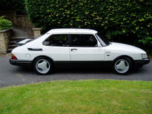 Caption: Majestic Saab 900 Turbo In Urban Setting Wallpaper