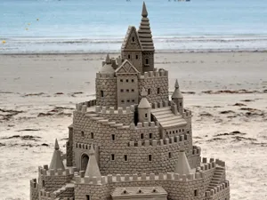 Caption: Majestic Sandcastles On A Sunny Beach Wallpaper