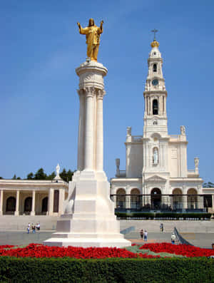 Caption: Majestic Statue Of Jesus At Fatima Sanctuary Wallpaper