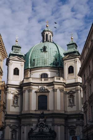 Caption: Majestic Vienna Cathedral Basking In The Evening Glow Wallpaper