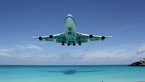 Caption: Majestic View Of An Airplane Taking Flight At Sunset Wallpaper