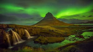 Caption: Majestic View Of Northern Lights In The Sky Wallpaper