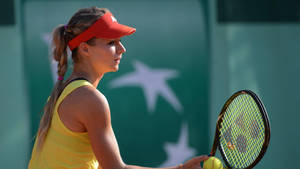 Caption: Maria Kirilenko Holding A Tennis Racket And Ball Wallpaper