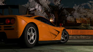 Caption: Mclaren F1 Supercar On The Open Road Wallpaper