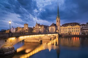 Caption: Mesmerizing Sunset Over Zurich’s Historic Skyline Wallpaper