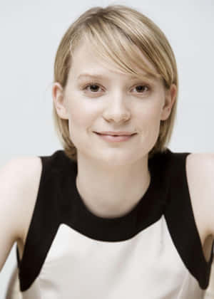 Caption: Mia Wasikowska Striking A Pose During A Photoshoot Wallpaper