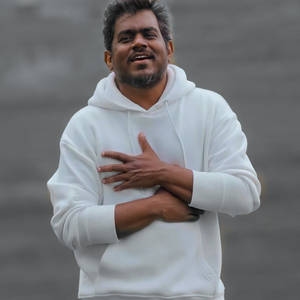 Caption: Music Maestro Yuvan Shankar Raja In A Stylish White Hoodie Wallpaper