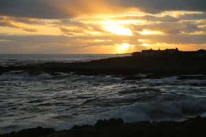 Caption: Mysterious Dark Island At Sunset Wallpaper