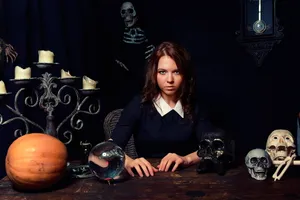 Caption: Mysterious Fortune Teller In A Candlelit Atmosphere Wallpaper