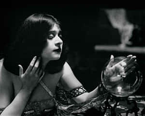 Caption: Mystic Crystal Ball On A Wooden Table Wallpaper