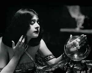 Caption: Mystic Crystal Ball On A Wooden Table Wallpaper