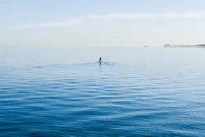 Caption: Peaceful Paddleboarding Adventure Wallpaper