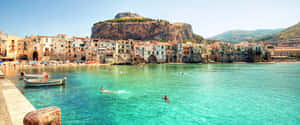 Caption: Picturesque Italian Island With Crystal Clear Waters Wallpaper