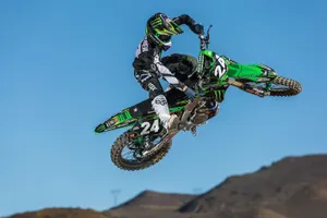 Caption: Powerful Monster Dirt Bike In Action Wallpaper