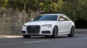 Caption: Pristine Audi S6 Unleashed On Open Road Wallpaper