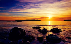 Caption: Pristine Yellow Beach At Sunset Wallpaper