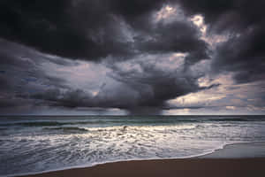 Caption: Refreshing Sea Breeze On A Sunny Day Wallpaper