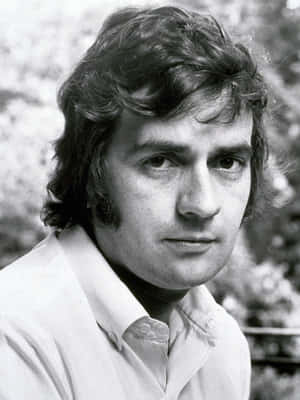 Caption: Renowned English Actor And Comedian Dudley Moore Posing For A Portrait Wallpaper