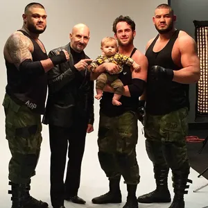 Caption: Roderick Strong With Paul Ellering And Authors Of Pain During A Wrestling Event. Wallpaper
