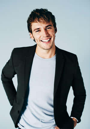 Caption: Sam Claflin Posing For A Photoshoot Wallpaper