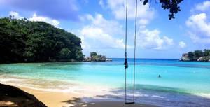 Caption: Serene Moments At Jamaica Beach Wallpaper