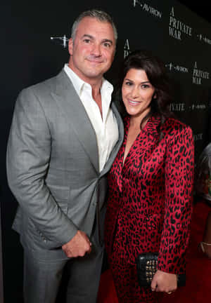 Caption: Shane Mcmahon With Marissa Mazzola Mcmahon Standing Together Wallpaper