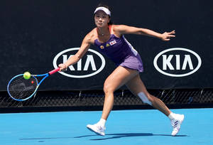 Caption: Shuai Peng In-action At The Blue Tennis Court. Wallpaper