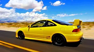 Caption: Sleek Acura Integra Gliding On The Open Road Wallpaper