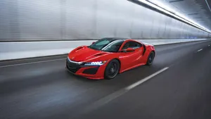 Caption: Sleek Acura Nsx With Vibrant Red Exterior Wallpaper