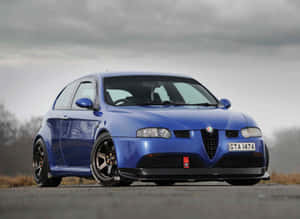 Caption: Sleek Alfa Romeo Gt On A Scenic Drive Wallpaper