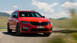 Caption: Sleek And Elegant Skoda Rapid Cruising On The Road Wallpaper