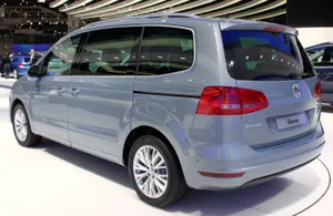 Caption: Sleek And Modern Volkswagen Sharan Parked By The Water Wallpaper
