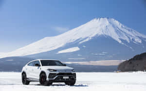 Caption: Sleek And Powerful Lamborghini Urus In Action Wallpaper