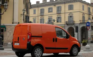 Caption: Sleek And Stylish Fiat Fiorino In Urban Setting Wallpaper