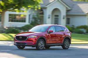 Caption: Sleek And Stylish Mazda Cx-5 In A Scenic Setting Wallpaper